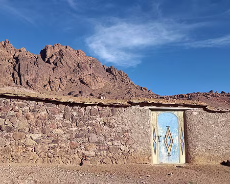 20251009_090257-01 Les portes en métal sont un des rares éléments colorés qui se détachent des constructions basses qui se fondent dans le paysage.